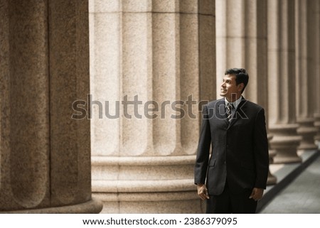 Indian businessman. Professional Lawyer or business man outside a colonial courthouse building. 
 Royalty-Free Stock Photo #2386379095