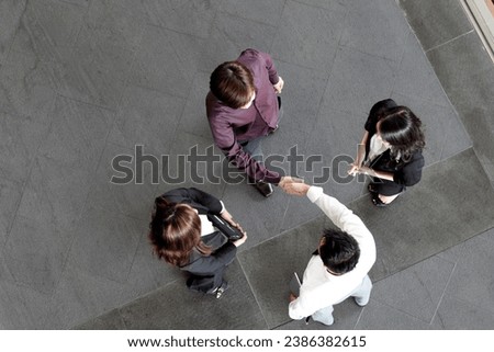 High angle view of Asian Business people shaking hands.  Royalty-Free Stock Photo #2386382615