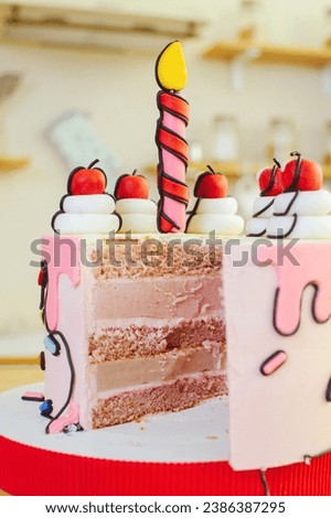 beautiful cake made in a cartoon style with a candle and cherries in a bright, close-up section