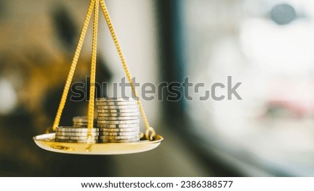 Coins stack with balance scale. Money management, financial plan, time value of money, business idea and Creative ideas for saving money concept. 