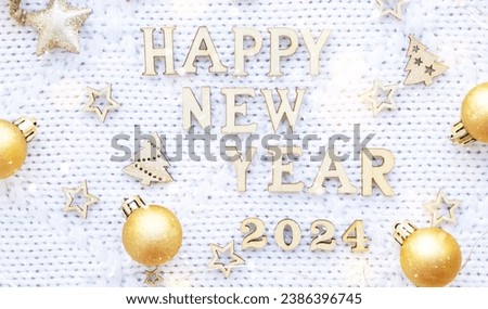 Happy New Year wooden letters and the numbers 2024 on cozy festive white knitted background with sequins, stars, lights of garlands. Greetings, postcard. Calendar, cover