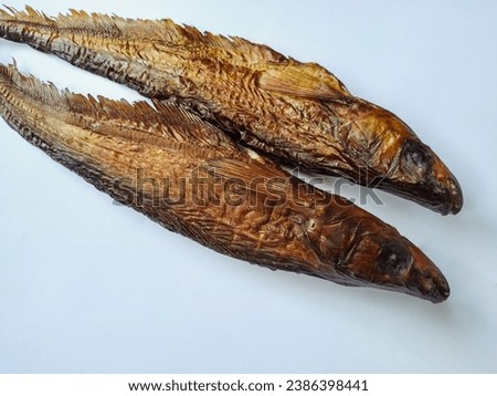 Smoked Asian Glass Catfish Isolated in the White Background Royalty-Free Stock Photo #2386398441