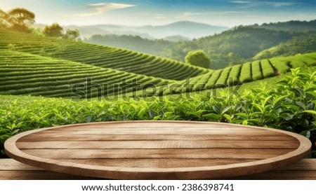 Circle wooden table top with blurred tea plantation landscape against blue sky and blurred green leaf frame Product display concept natural background  Royalty-Free Stock Photo #2386398741