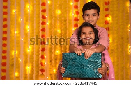 Happy kids celebrating diwali festival,holding gift boxes