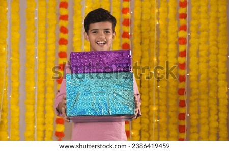 Happy kids celebrating diwali festival,holding gift boxes