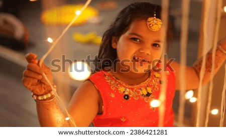 Happy Indian Kid girl Celebrating diwali