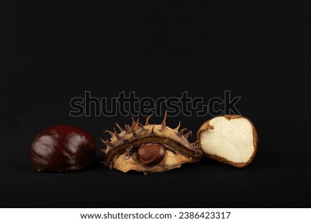 Chestnuts with peel shot on black background