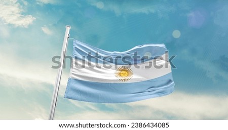 Argentina national flag waving in beautiful sky. Royalty-Free Stock Photo #2386434085