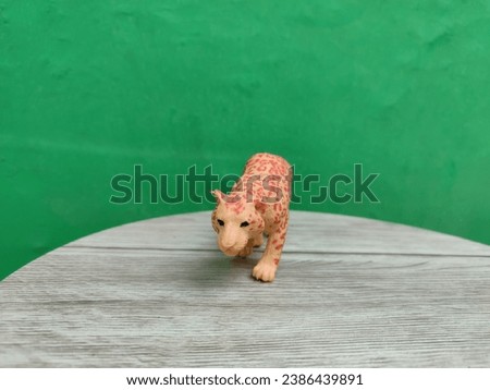 Miniature cheetah on a green background