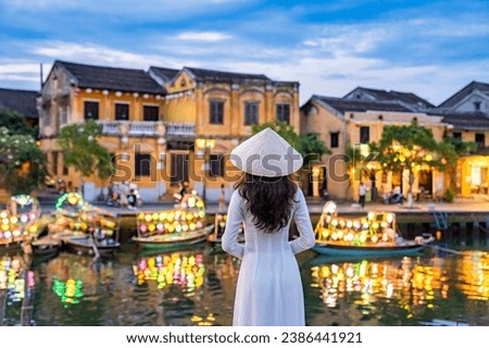 Asian woman wearing vietnam culture traditional at Hoi An ancient town, Vietnam. Hoi An is one of the most popular destinations in Vietnam  from Korea, Thailand, USA, Japan, China
 Royalty-Free Stock Photo #2386441921