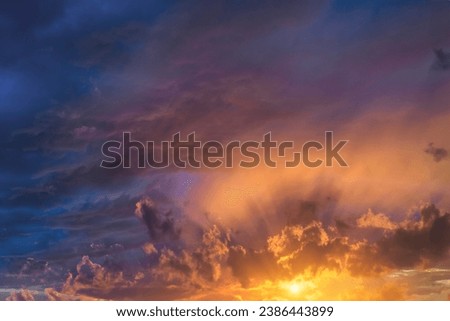 Glowing real sky at sunset texture background overlay. Dramatic red, orange, and purple clouds. High resolution photography perfect for sky replacement