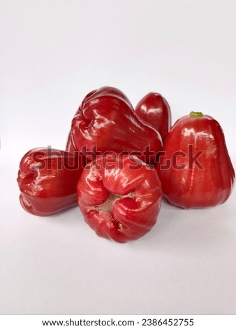 Rose Apple is the fruit with dark red skin and a sweet, crisp taste. Bell-shaped fruit. Royalty-Free Stock Photo #2386452755