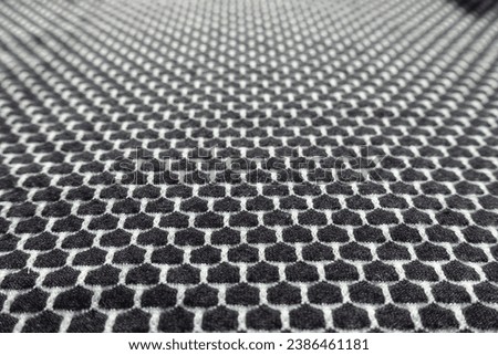 Closeup of black and white jersey fabric with honeycomb pattern