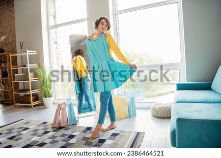 Full length photo of adorable stunning girl trying on new outfit dress mirror indoors house room nice flat Royalty-Free Stock Photo #2386464521