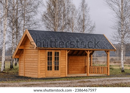 Small wooden house in the countryside during autumn season Royalty-Free Stock Photo #2386467597