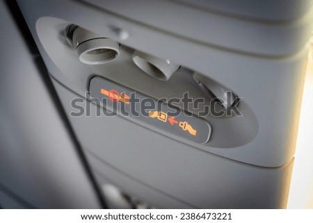 Fasten seat belt and no smoking signs in aircraft, overhead console of conditioner in a airplane. signs in the plane.