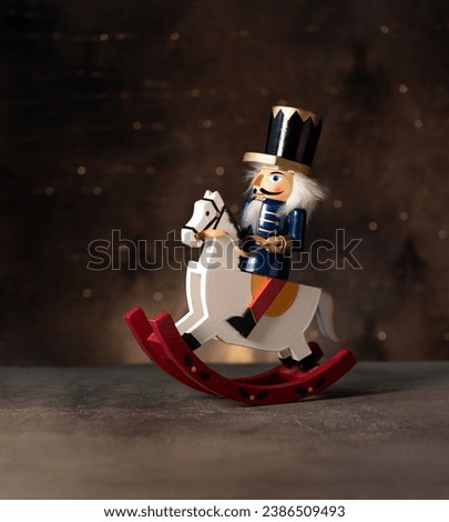 Christmas  nutcracker on horse on  dark background with bokeh
