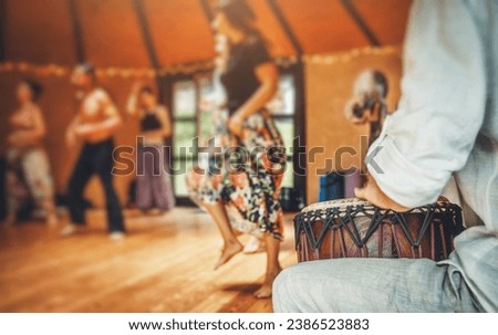 Drummer playing the djembe at the cacao ceremony. Ceremony dance in circle. Ceremony space. Royalty-Free Stock Photo #2386523883