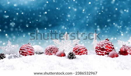 Christmas texture with red christmas balls in the snow
