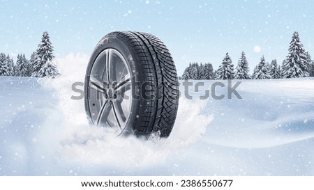 Wheels with winter tires in the snow on a background of a winter forest, concept. Winter tires, creative idea. Winter safety and transport. Emergency braking Royalty-Free Stock Photo #2386550677