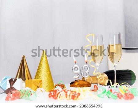 Date of Birth  93. Festive background with a bottle of champagne. Festive Champagne in glasses with gift boxes, anniversary card, happy birthday decorations in white colors Royalty-Free Stock Photo #2386554993