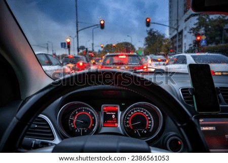 Autumn traffic jams on the road seen through the car windshield Royalty-Free Stock Photo #2386561053