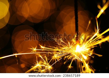 Beautiful sparkler on shiny background, close up