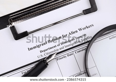 I-140 Immigrant petition for alien workers blank form on A4 tablet lies on office table with pen and magnifying glass close up Royalty-Free Stock Photo #2386574315