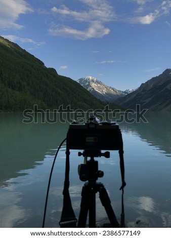 film camera on a tripod on the lake