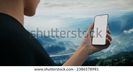 CU Caucasian womanusing her phone during hiking trip, daytime. Blank screen travel, weather application smartphone mockup