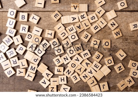 English alphabet. Wooden letters on a wooden background. A letter mess.