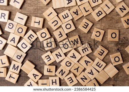 English alphabet. Wooden letters on a wooden background. A letter mess.
