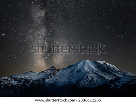 Majestic view of the night sky over Mount Rainier, featuring a bright Milky Way illuminating the majestic mountain range below Royalty-Free Stock Photo #2386612285