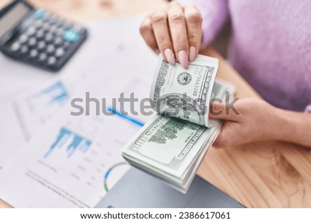 Young caucasian woman ecommerce business worker holding dollars accounting at office