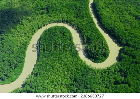 aerial Meandering river through vibrant green forest Costa Rica