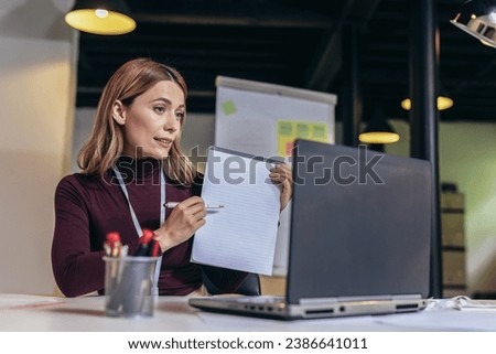 Young businesswoman working on her laptop in the modern office and make video call.