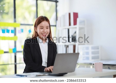 Beautiful Businesswoman typing on laptop