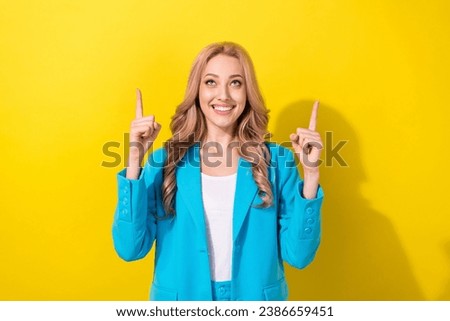 Photo of stunning positive lady look direct fingers up above empty space isolated on yellow color background
