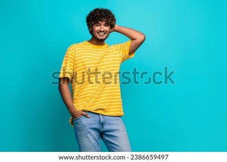 Photo portrait of handsome young guy touch scratch back head dressed stylish striped yellow outfit isolated on cyan color background