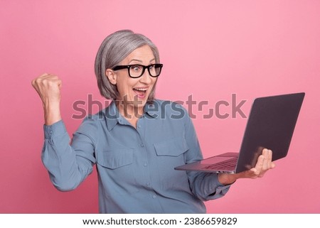 Photo of charming cheeful retired lady wear stylish clothes speaking onlie zoom skype meeting conference isolated on pink color background