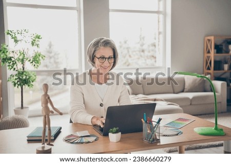 Photo of good mood positive senior lady dressed white cardigan communicating modern device indoors house room