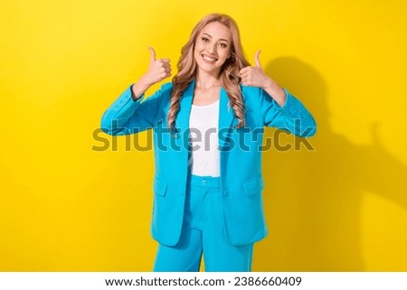 Photo of stunning cheerful lady beaming smile arms fingers demonstrate thumb up isolated on yellow color background