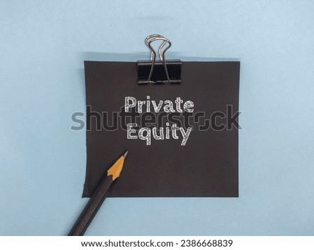 Photo display of a paper clip with the word "Private Equity" in pencil on a blue background. Business theme concept.