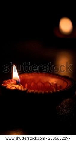 Lowkey Photograph of Diya in Diwali, Hindu festival of lights celebration. Diya oil lamp against dark background Low Key Photo, 9:16 Ratio good for mobile wallpaper High qaulity.