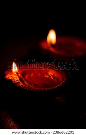 Lowkey Photograph of Diya in Diwali, Hindu festival of lights celebration. Diya oil lamp against dark background Low Key Photo, 9:16 Ratio good for mobile wallpaper High qaulity.