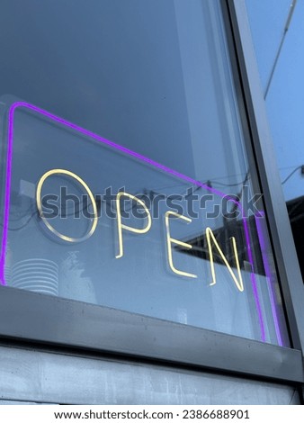 Neon sign "OPEN" on the window of a cafe
