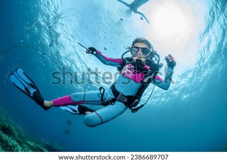 Child scuba diver underwater in the ocean