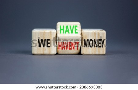 We have or not money symbol. Concept word We have or have not money on beautiful wooden cubes. Beautiful grey table grey background. Business and we have or not money concept. Copy space.