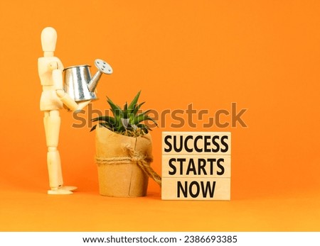 Success starts now symbol. Concept word Success starts now on beautiful wooden block. Businessman model. Beautiful orange table background. Business motivational success starts now concept. Copy space Royalty-Free Stock Photo #2386693385