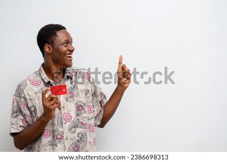 photo of young man holding atm card and pointing to a copy space. Black Friday sale